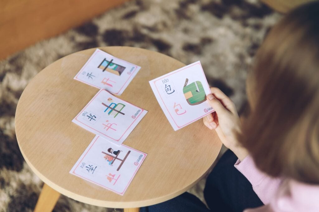 a kid playing GoEast kids Chinese character cards