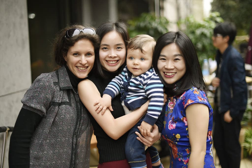 GoEast Mandarin teachers and students celebrating at an anniversary party with their children