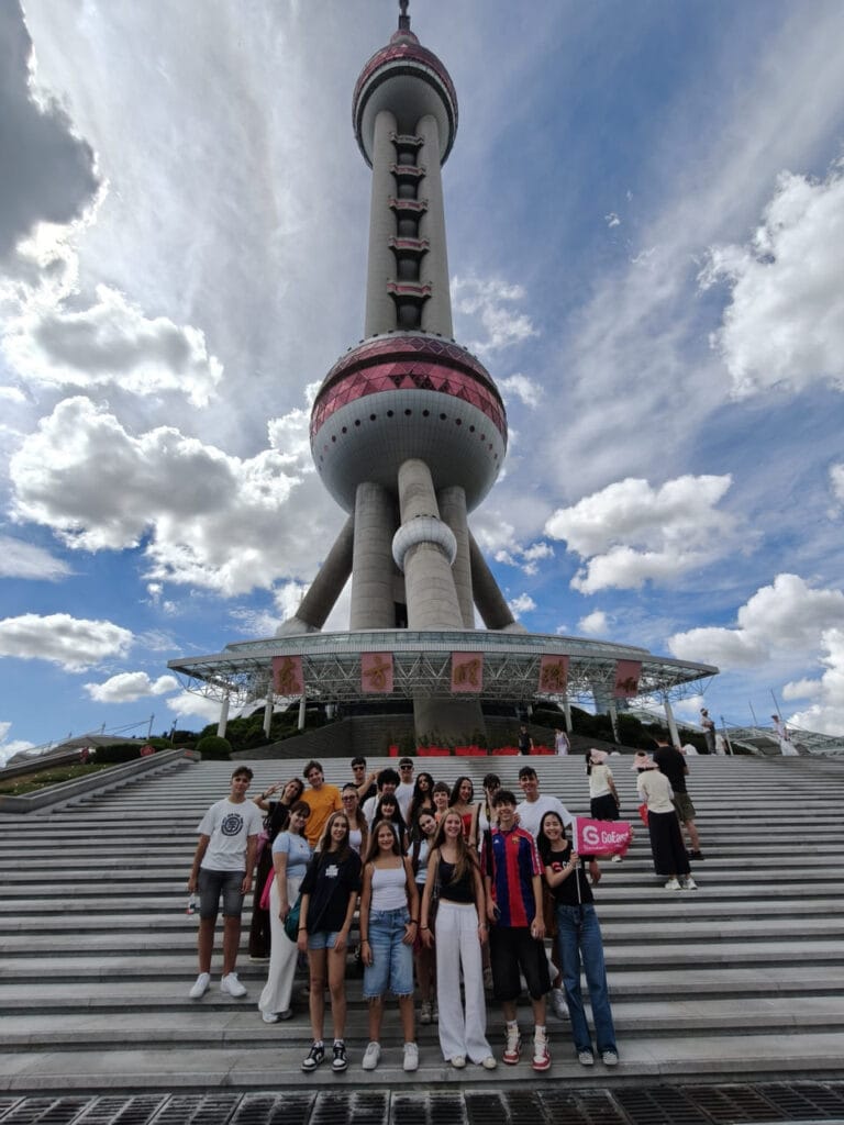 Italian school group posing in front of the Oriental Pearl Tower in Shanghai