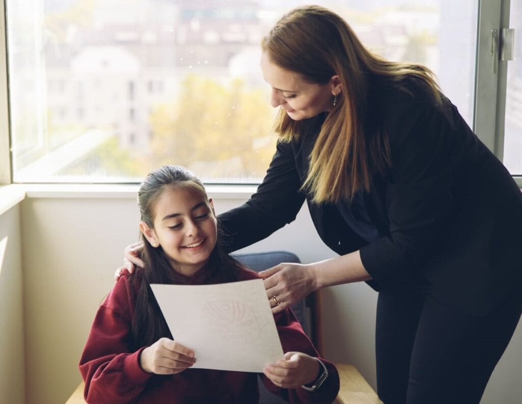 A child and her mother talking happily after Chinese class