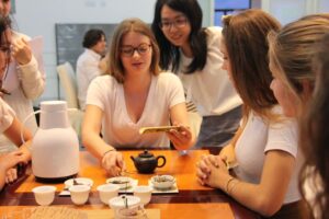 School trip students learning Chinese tea ceremony