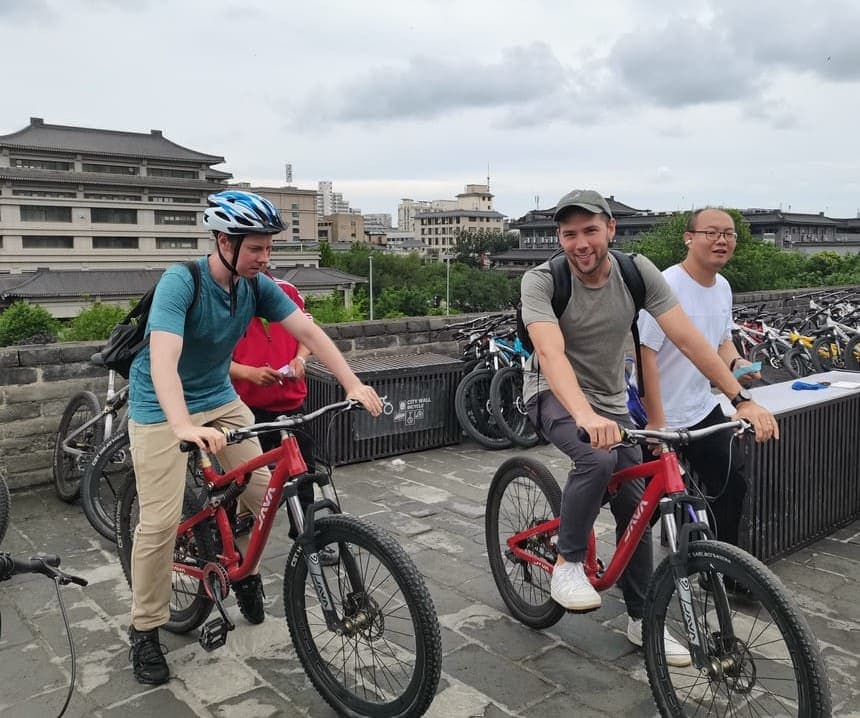 School trip students cycling on the ancient Xi'an City Wall