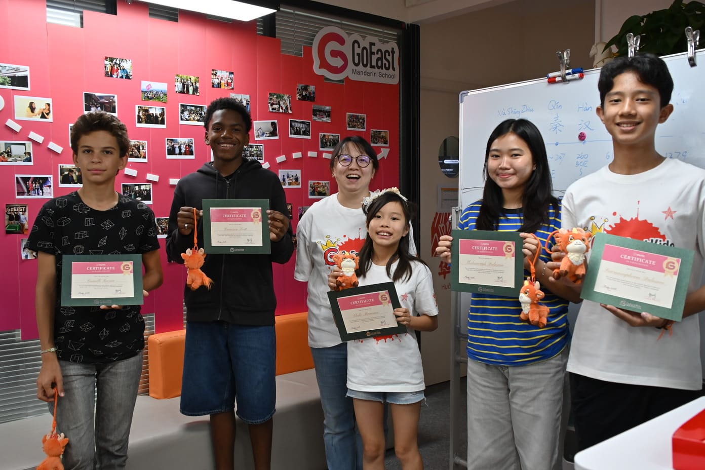 GoEast kids summer camp students showing their certificate